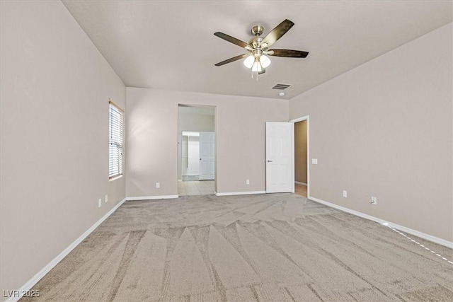 unfurnished room featuring light colored carpet and ceiling fan