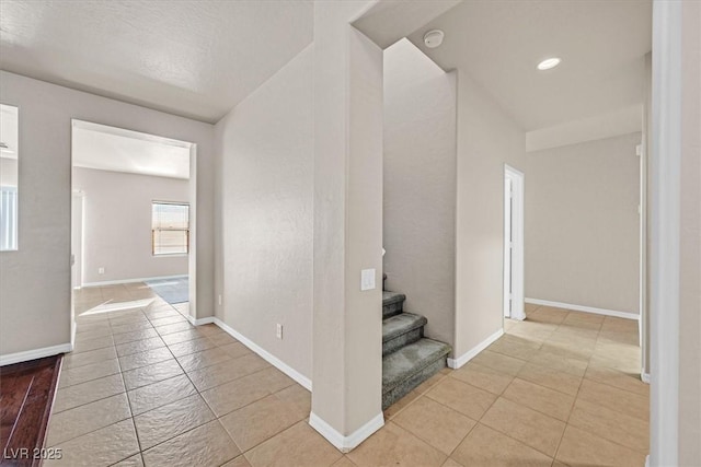 hall featuring light tile patterned floors