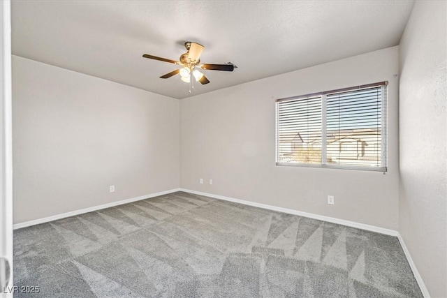 spare room featuring carpet and ceiling fan