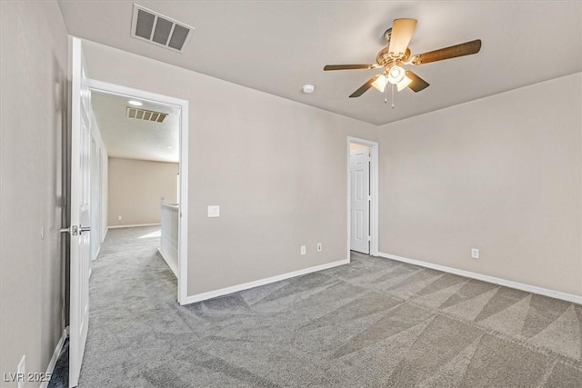 spare room featuring ceiling fan and light colored carpet