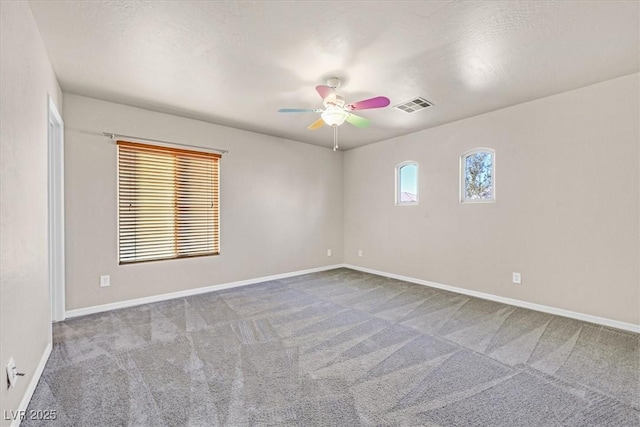 carpeted empty room with ceiling fan