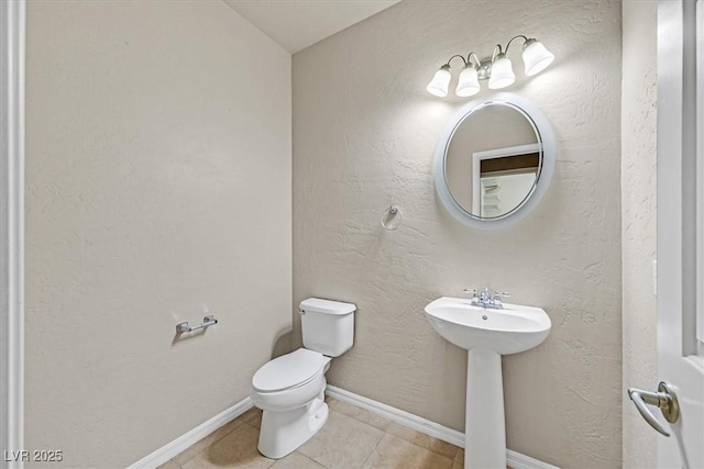 bathroom with tile patterned flooring, sink, and toilet