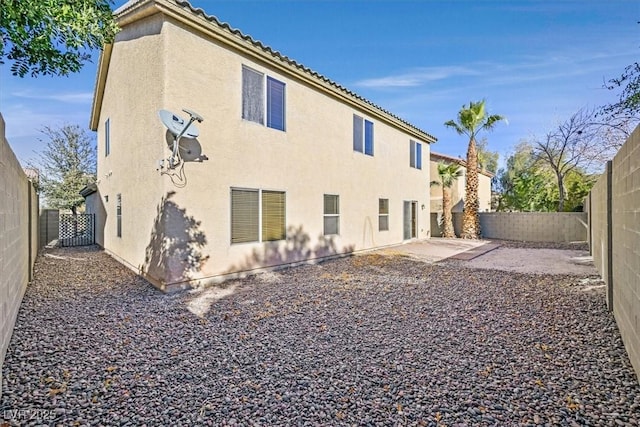 rear view of property featuring a patio area