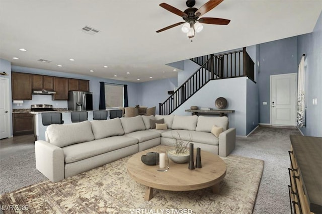 carpeted living room featuring ceiling fan