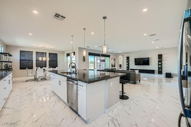 kitchen with dishwasher, white cabinetry, hanging light fixtures, and sink