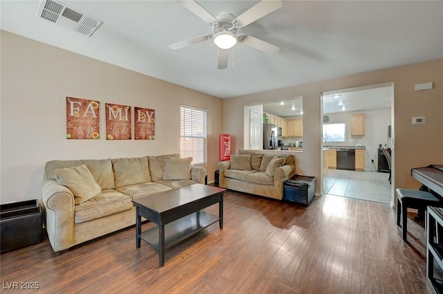 living room featuring hardwood / wood-style floors and ceiling fan