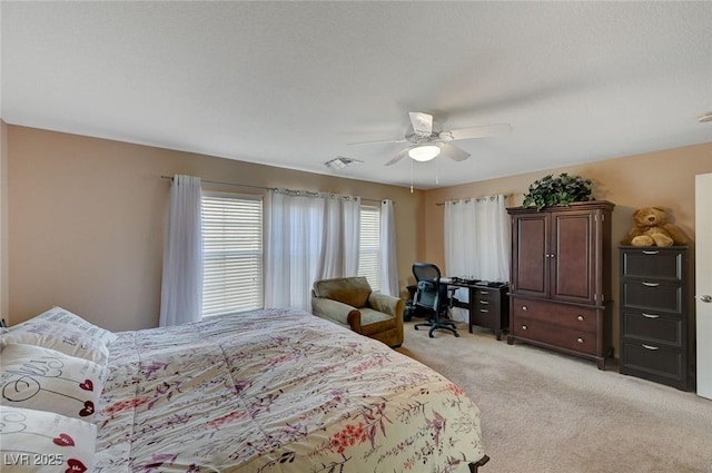 bedroom with light carpet and ceiling fan