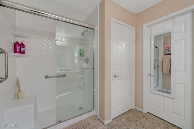 bathroom with a shower with shower door