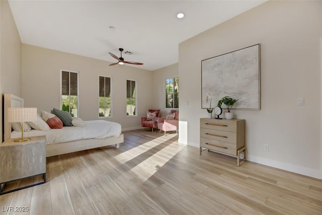 bedroom with ceiling fan and light hardwood / wood-style floors