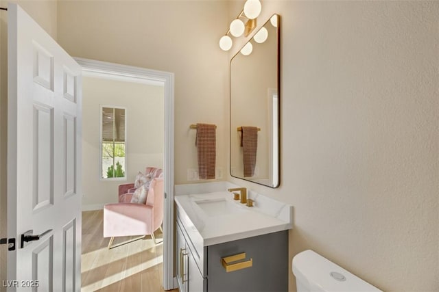 bathroom featuring hardwood / wood-style flooring, vanity, and toilet