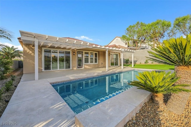 rear view of property featuring a pergola and a patio area