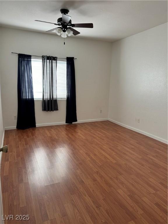 spare room featuring ceiling fan and hardwood / wood-style floors