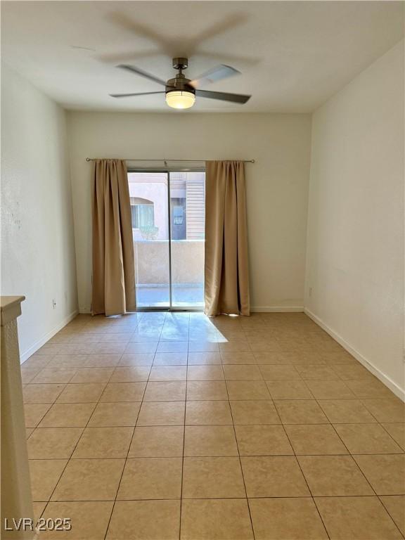 spare room featuring ceiling fan and light tile patterned floors