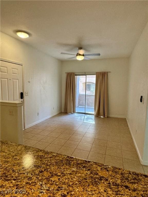 tiled empty room with ceiling fan