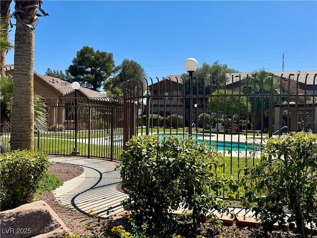 view of swimming pool with a lawn