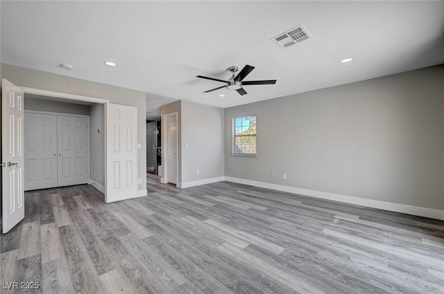 unfurnished bedroom with baseboards, visible vents, ceiling fan, light wood-type flooring, and recessed lighting