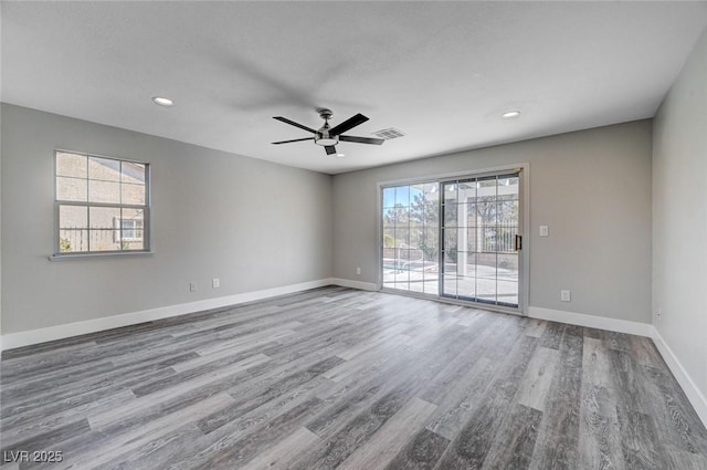 empty room featuring recessed lighting, visible vents, a ceiling fan, wood finished floors, and baseboards