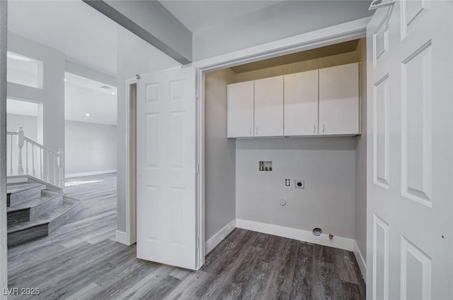 laundry room featuring cabinet space, hookup for a gas dryer, wood finished floors, hookup for an electric dryer, and washer hookup