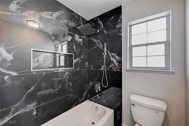 bathroom featuring shower / tub combination and toilet