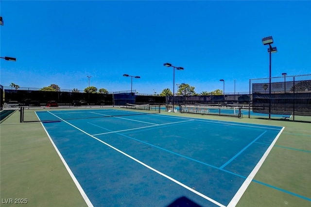 view of sport court featuring fence