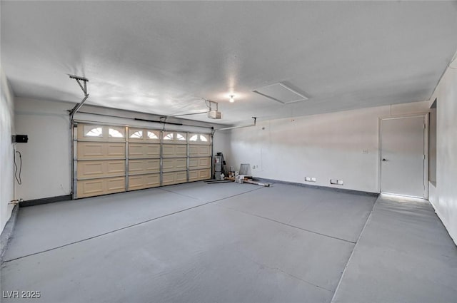 garage featuring a garage door opener and baseboards