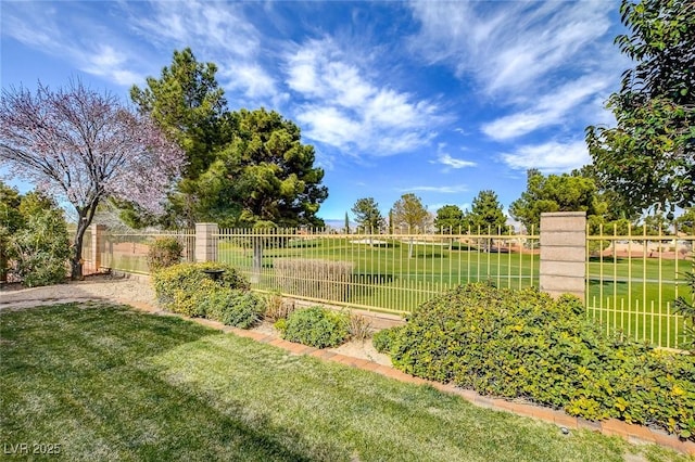 view of home's community featuring fence and a lawn