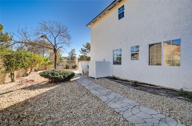 view of property exterior with a fenced backyard and stucco siding