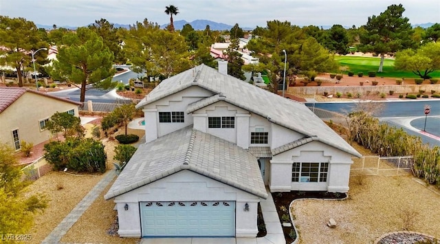 view of front of house featuring a tiled roof and an attached garage