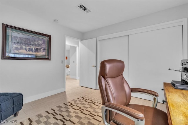 home office with light hardwood / wood-style floors