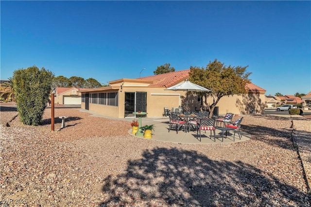 back of house with a patio