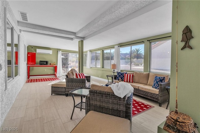 sunroom featuring an AC wall unit and beam ceiling