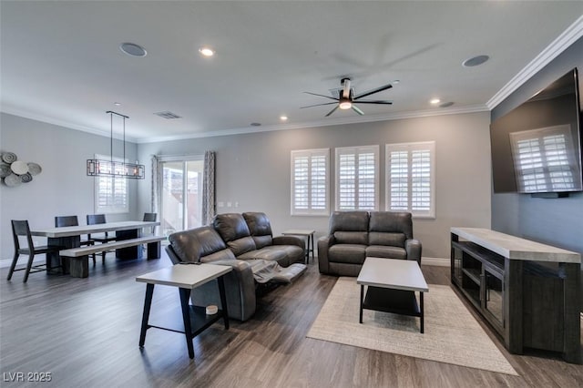 living room featuring ornamental molding and a wealth of natural light