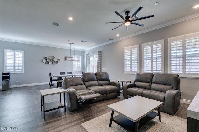 living room with crown molding, plenty of natural light, dark hardwood / wood-style floors, and ceiling fan