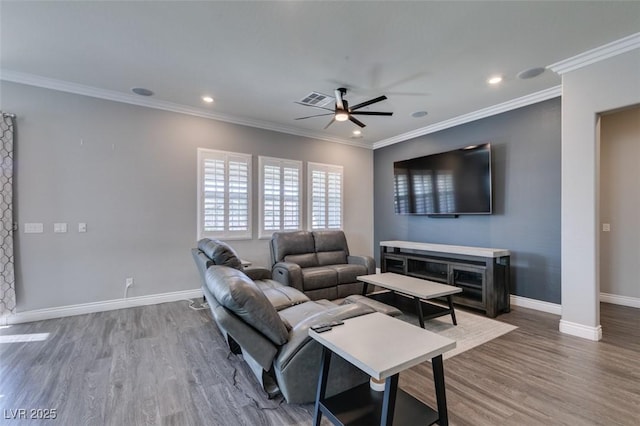 living room with hardwood / wood-style flooring, ornamental molding, and ceiling fan