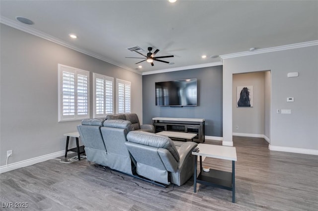 living room featuring hardwood / wood-style floors, ornamental molding, and ceiling fan