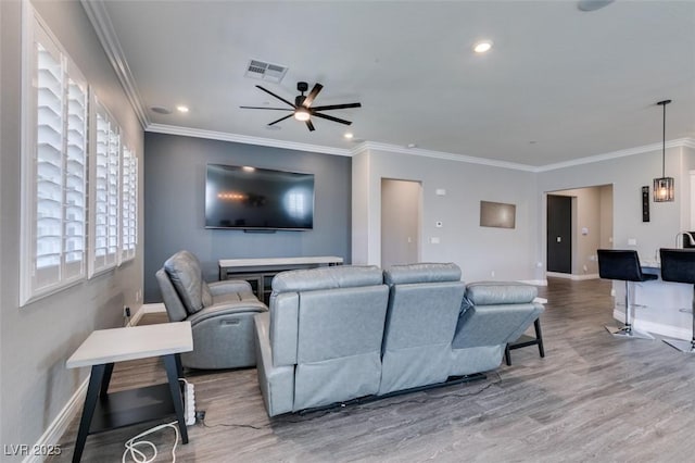 living room featuring ceiling fan, ornamental molding, and hardwood / wood-style floors