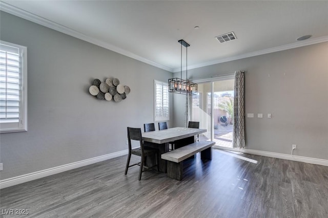 dining area with crown molding, dark hardwood / wood-style floors, and a wealth of natural light