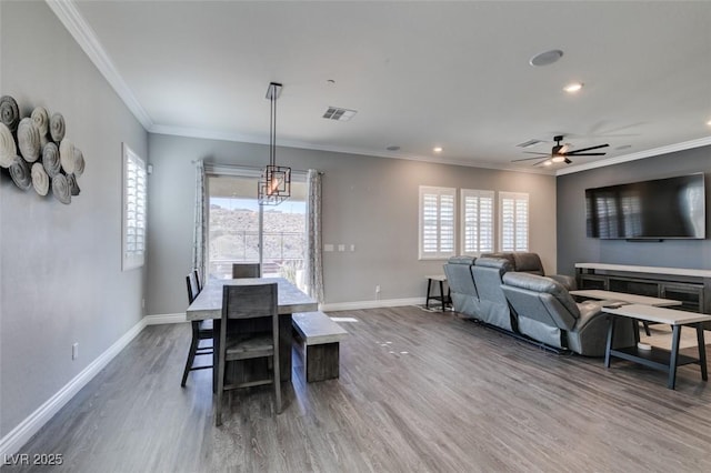 dining area with crown molding, hardwood / wood-style flooring, and plenty of natural light