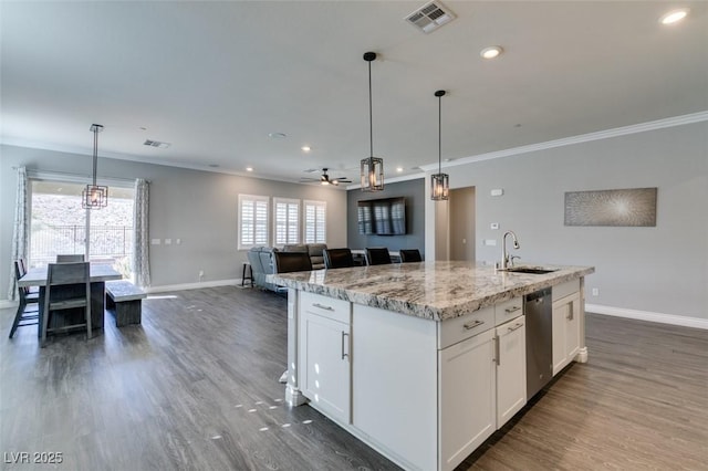 kitchen featuring white cabinetry, sink, light stone counters, and a center island with sink