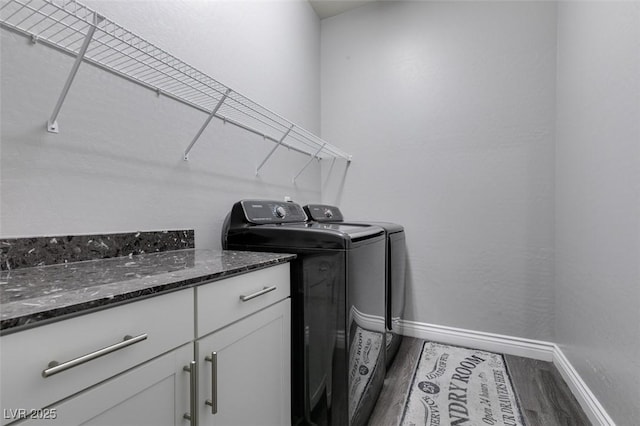 washroom with dark wood-type flooring and washing machine and clothes dryer