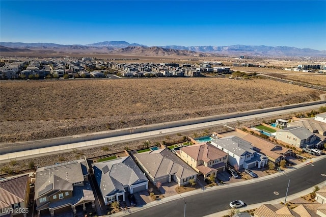 birds eye view of property with a mountain view