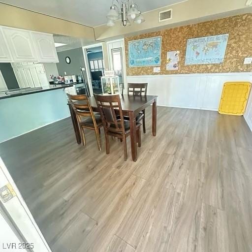 dining room featuring light hardwood / wood-style flooring and a chandelier