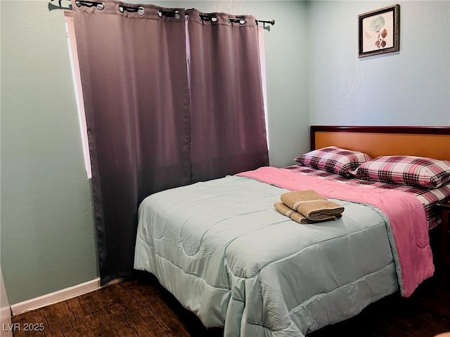 bedroom featuring dark hardwood / wood-style flooring