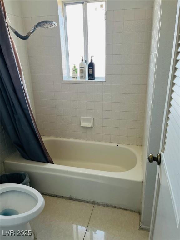 bathroom with shower / bath combo, tile patterned floors, and toilet