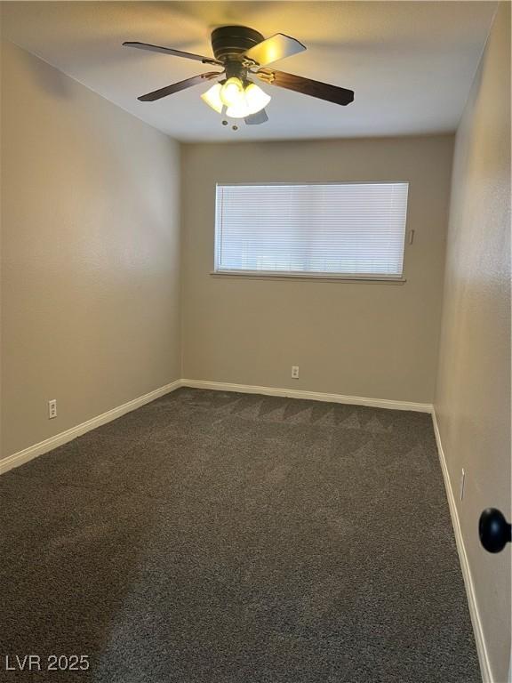 empty room with ceiling fan and carpet floors