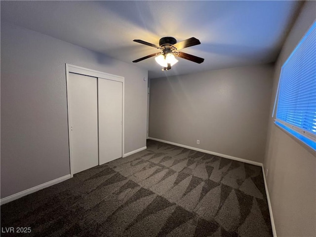 unfurnished bedroom featuring ceiling fan, a closet, and carpet