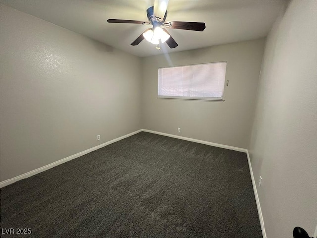 empty room with ceiling fan and dark carpet