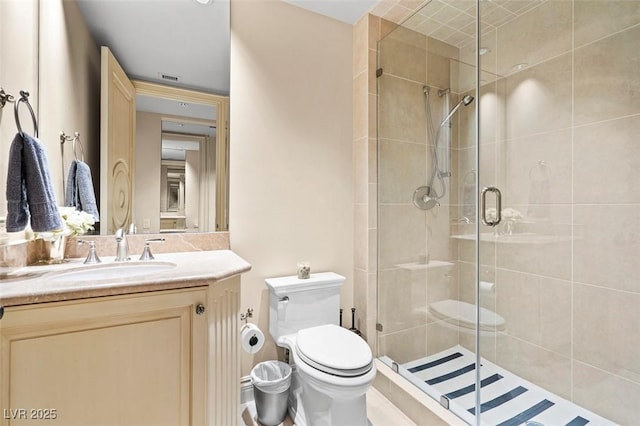 bathroom with vanity, toilet, and walk in shower