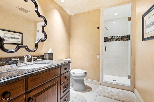 bathroom featuring vanity, a shower with door, tile patterned floors, and toilet