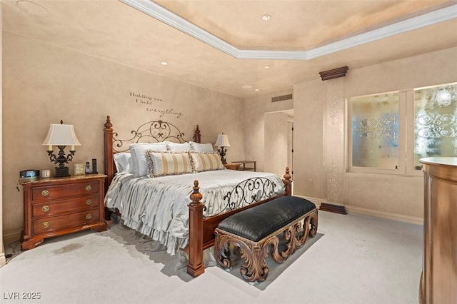 bedroom with ornamental molding, a raised ceiling, and carpet